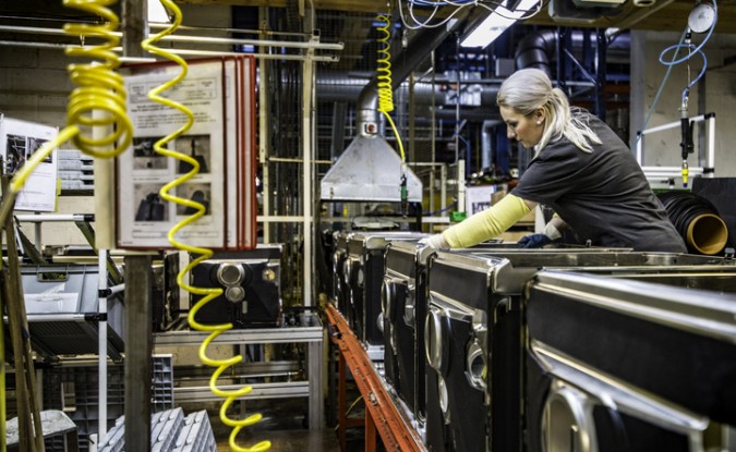 A woman works on an assembly line.