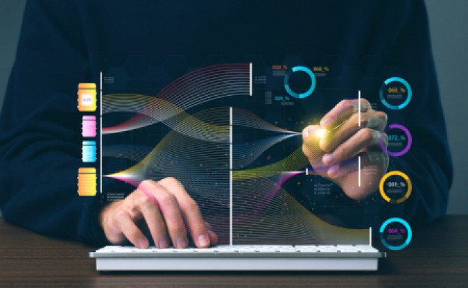 Stock photo with abstract graphics representing data analysis overlaid over photo of person wearing black shirt using his hands to work on a keyboard.