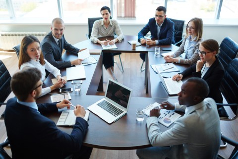 People around a table during a meeting at the office